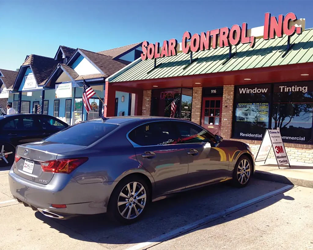 Car parked in front of Solar Control Inc window tinting business storefront